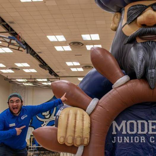 inflatable pirate with energetic student pointing up to it